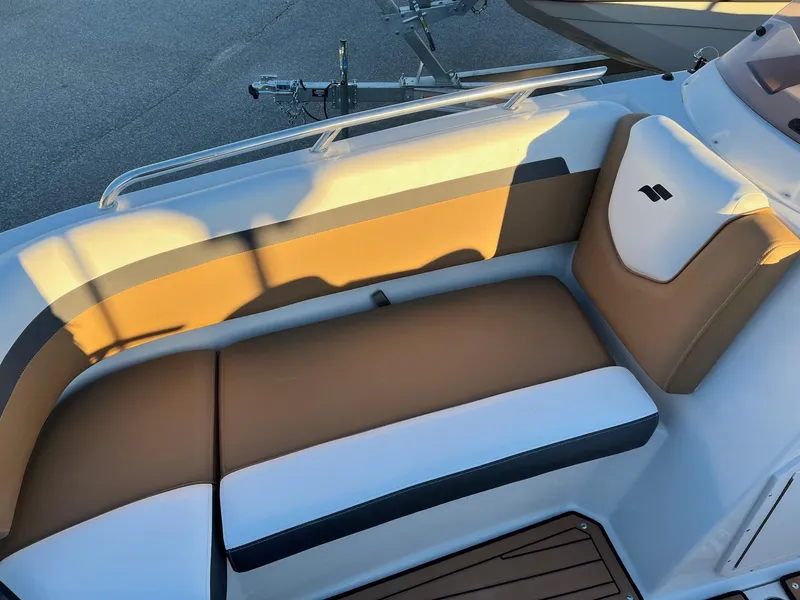Slide: The Image of 2024 Starcraft SVX 191 boat interior seating with tan and white upholstery. - 17