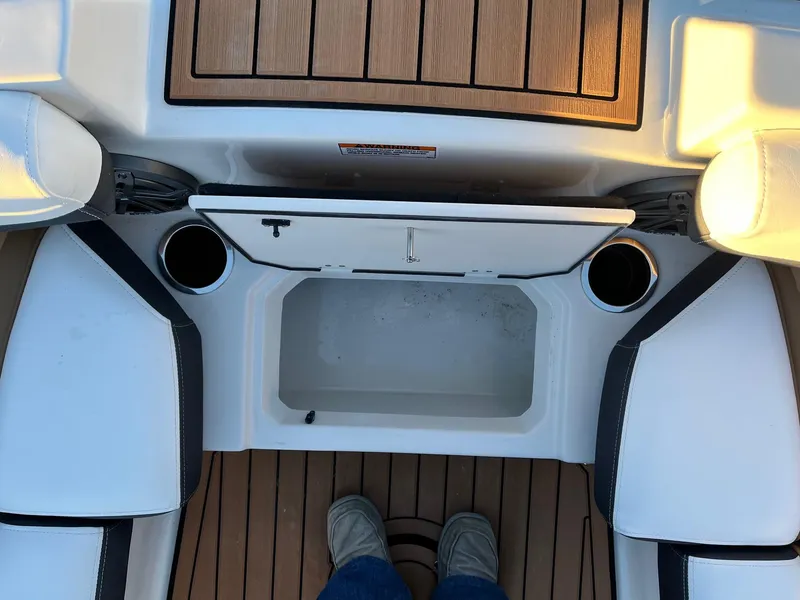 Slide: The Image of 2024 Starcraft SVX 191 boat interior with storage compartment and cup holders. - 18
