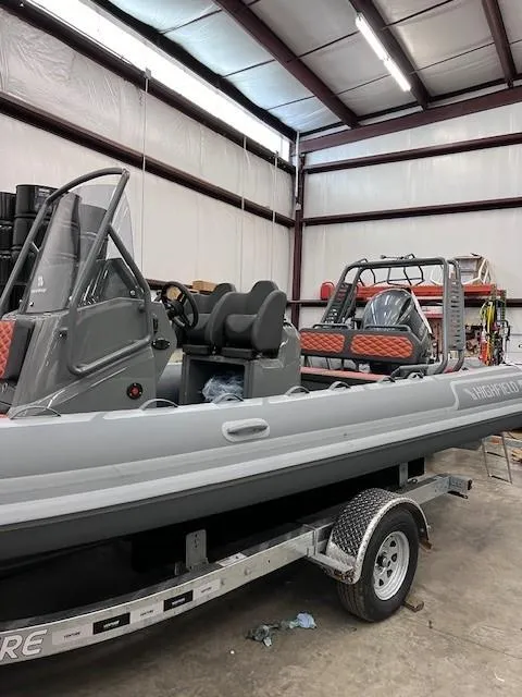 Slide: The Image of 2024 Highfield Sport 660 boat in a warehouse on a trailer. - 12