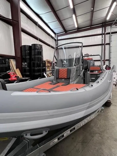 Slide: The Image of 2024 Highfield Sport 660 inflatable boat in a warehouse on a trailer. - 14