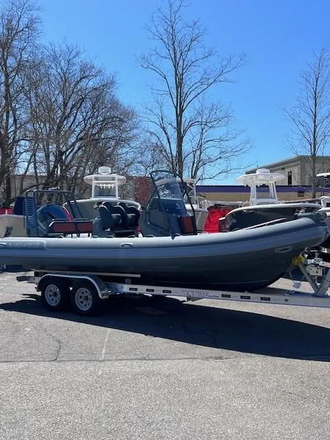 Slide: The Image of 2024 Highfield Sport 660 boat on a trailer in a parking lot. - 2