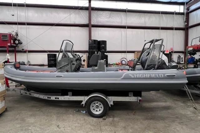 Slide: The Image of 2024 Highfield Sport 660 inflatable boat on a trailer in a warehouse. - 3
