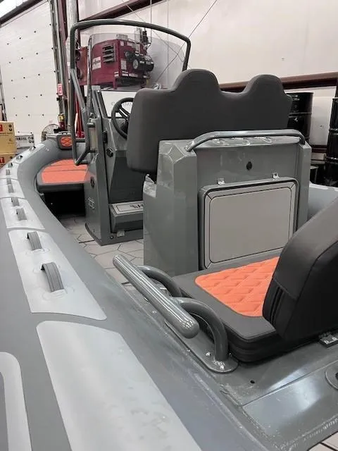 Slide: The Image of 2024 Highfield Sport 660 inflatable boat with orange seats and grey interior. - 6