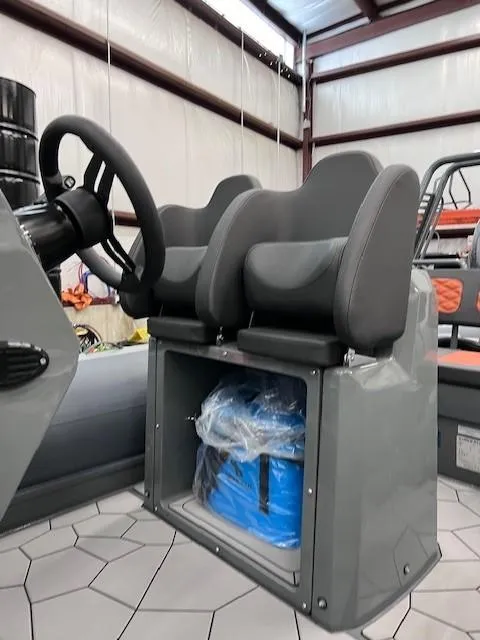 Slide: The Image of 2024 Highfield Sport 660 boat interior with dual seats and storage compartment. - 9