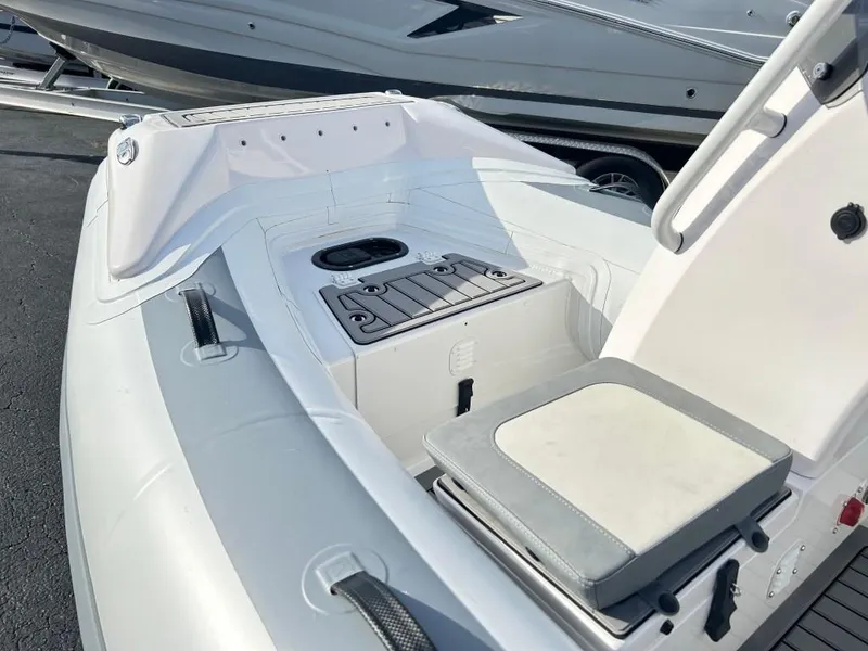 Slide: The Image of 2023 Highfield Sport 330 inflatable boat interior with seating and storage compartments. - 10