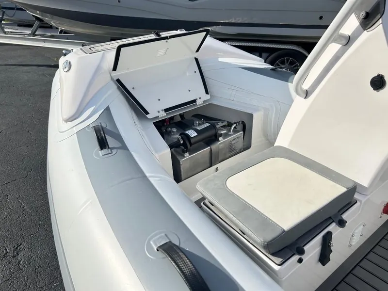 Slide: The Image of 2023 Highfield Sport 330 boat with open storage compartment and seating. - 11