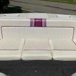 Slide: The Image of 1993 American Skier Legend boat interior with white and purple seating. - 8
