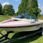 Slide: The Image of 1993 American Skier Legend boat on a trailer in a grassy area. - 9