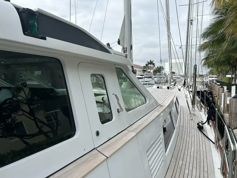 Slide: The Image of 1983 Palmer Johnson 110 Cruising Sloop docked, showcasing deck and cabin details. - 12