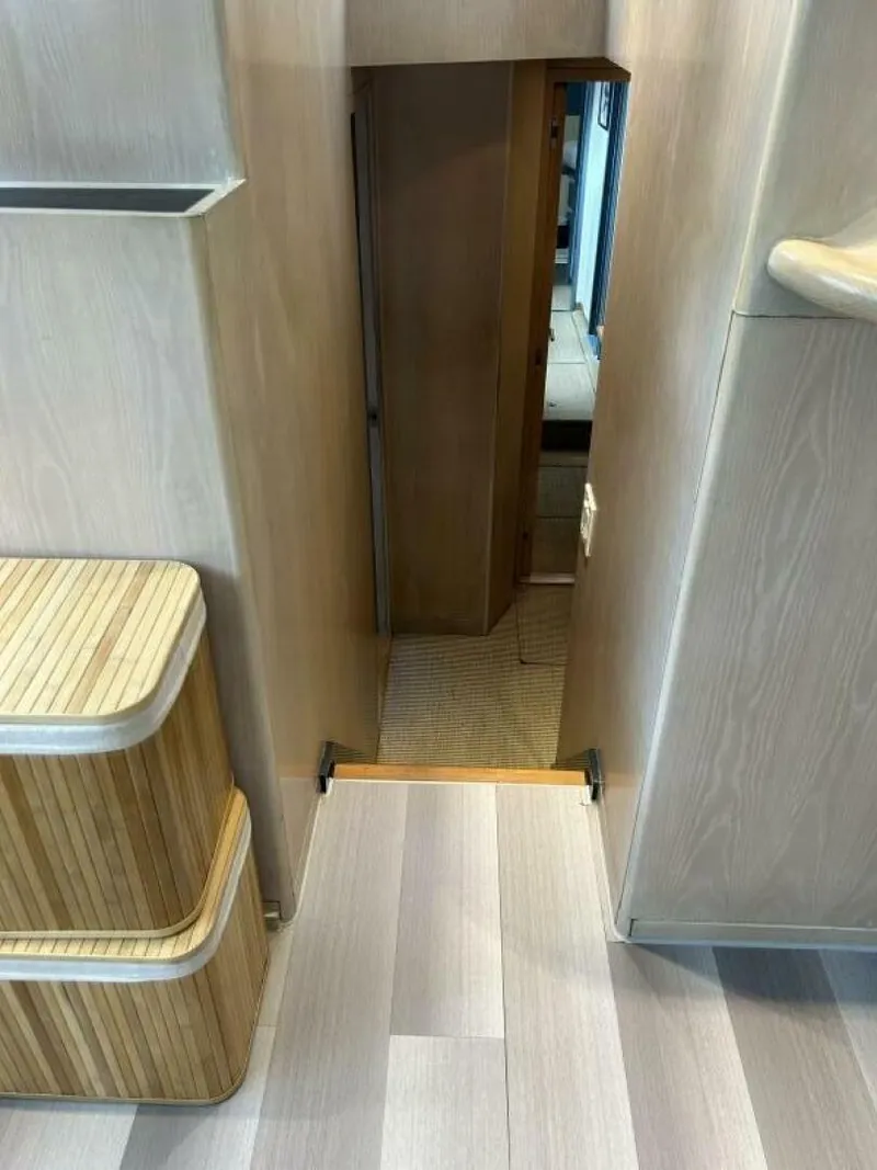 Slide: The Image of Interior of 1983 Palmer Johnson 110 Cruising Sloop with wooden steps and hallway. - 47