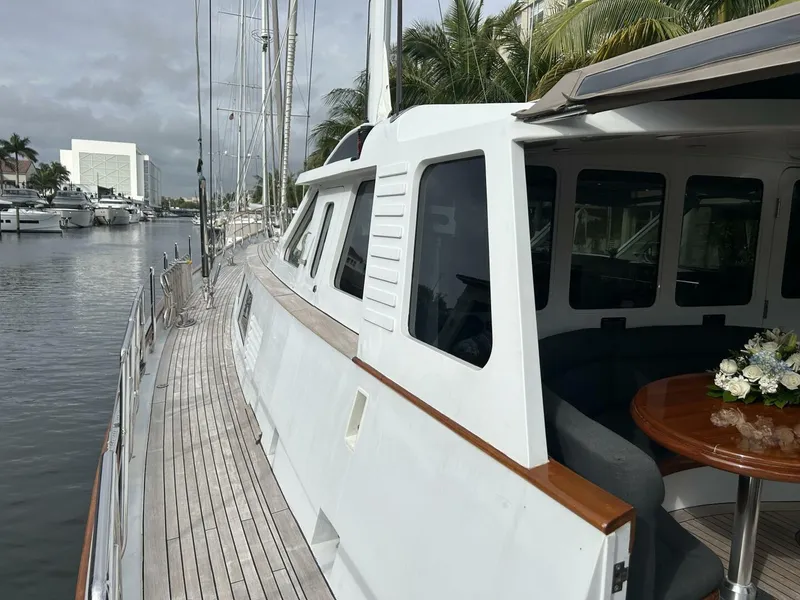 Slide: The Image of Palmer Johnson 110 Cruising Sloop 1983 docked, showcasing deck and cabin area. - 5