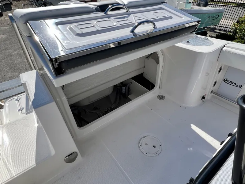 Slide: The Image of 2024 Robalo R230 boat interior with open storage compartment and sleek design. - 13