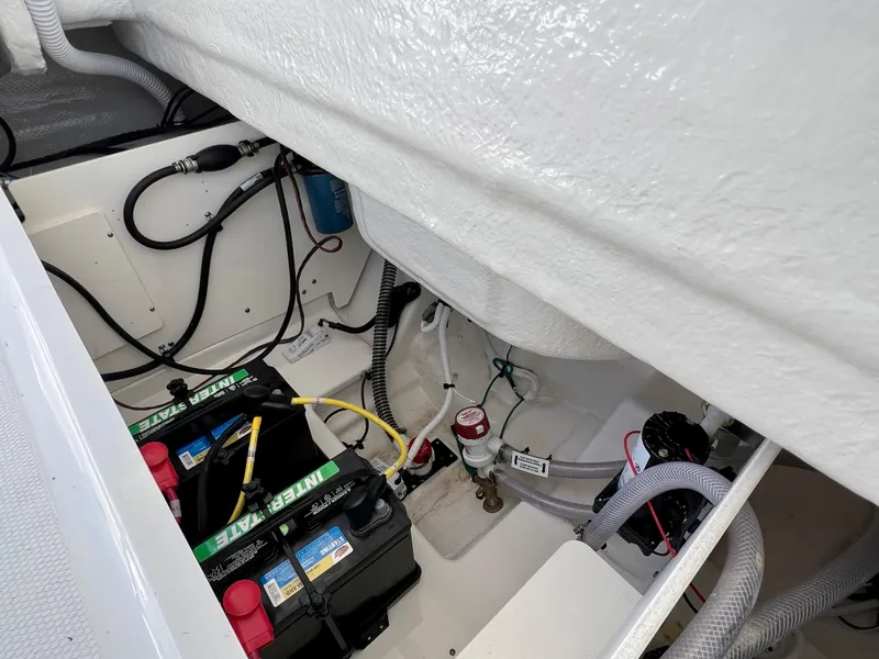 Slide: The Image of 2024 Robalo R230 boat battery compartment with wiring and components. - 15