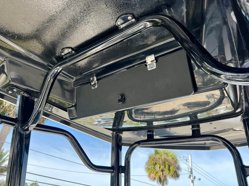 Slide: The Image of 2024 Robalo R230 boat T-top storage compartment and frame. - 18