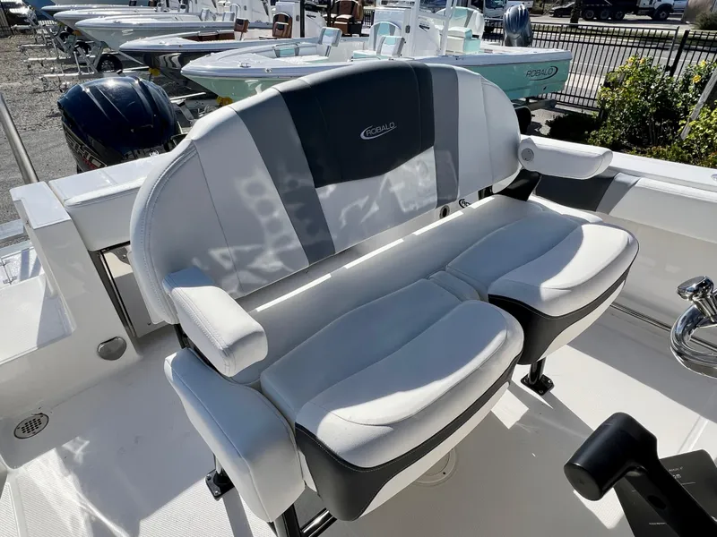 Slide: The Image of 2024 Robalo R230 boat seating area with cushioned seats and armrests. - 20