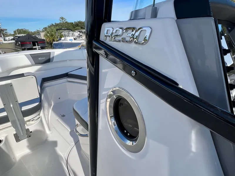 Slide: The Image of 2024 Robalo R230 boat interior with seating and storage compartments. - 23