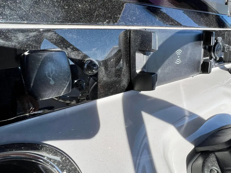 Slide: The Image of Close-up of 2024 Robalo R230 boat's USB port and wireless charging station. - 33