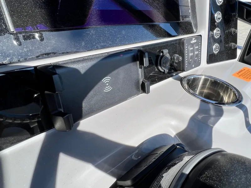 Slide: The Image of 2024 Robalo R230 boat dashboard with wireless charging pad and control panel. - 34