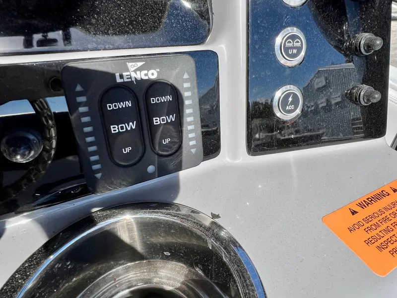 Slide: The Image of Control panel of 2024 Robalo R230 boat with Lenco trim tab switches. - 35