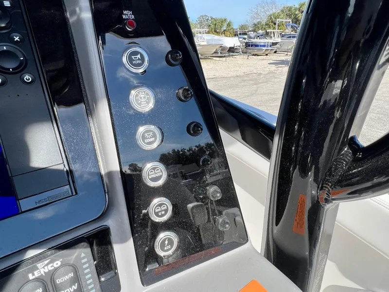 Slide: The Image of Control panel of 2024 Robalo R230 boat with various function buttons. - 36