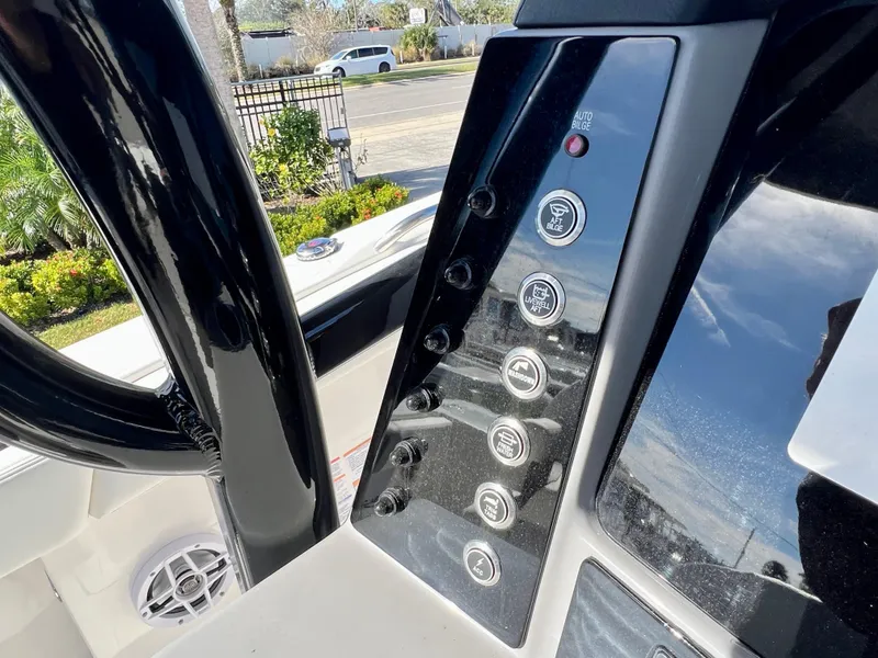 Slide: The Image of Control panel of a 2024 Robalo R230 boat with various function buttons. - 39