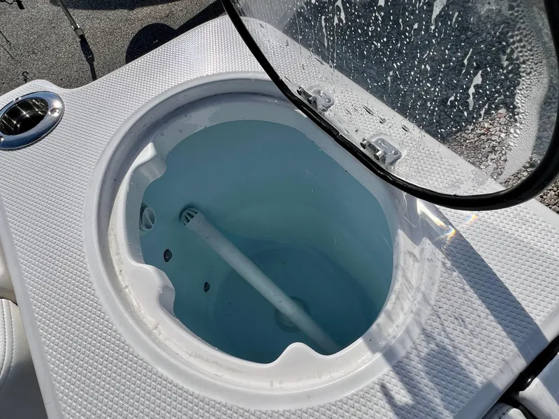 Slide: The Image of Livewell on 2024 Robalo R230 boat with open lid and water inside. - 41