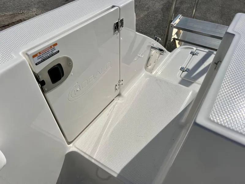 Slide: The Image of 2024 Robalo R230 boat deck with storage compartment and non-slip surface. - 42