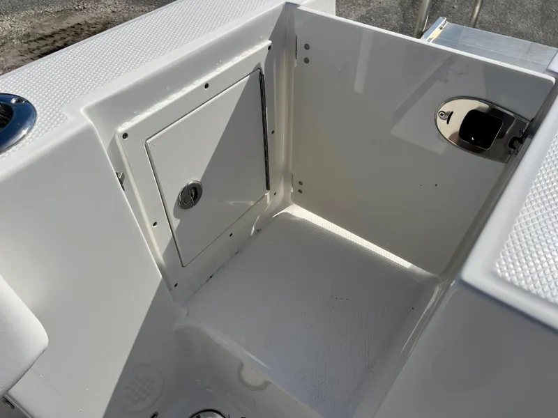 Slide: The Image of 2024 Robalo R230 boat storage compartment and seating area. - 43