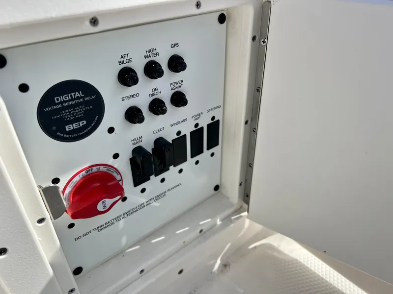 Slide: The Image of Control panel of 2024 Robalo R230 boat with various switches and digital relay. - 44