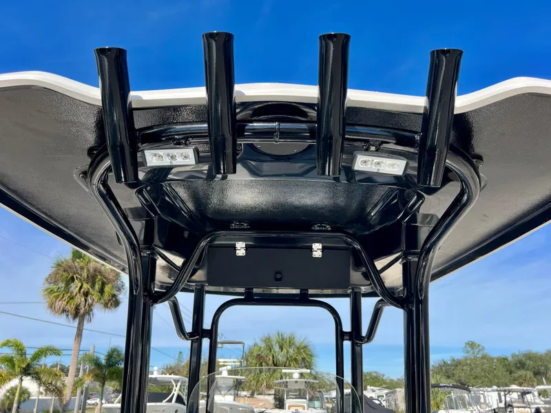 Slide: The Image of 2024 Robalo R230 boat T-top with rod holders and LED lights. - 45