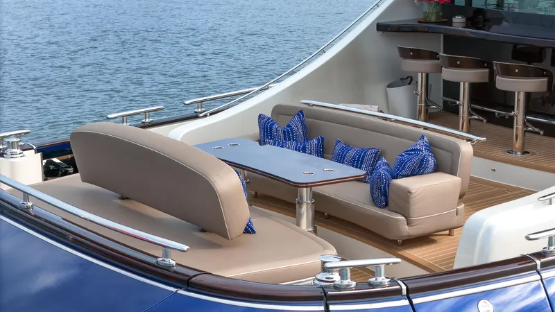 Slide: The Image of Luxury seating area on 2023 Zeelander 72 yacht with blue cushions and ocean view. - 20