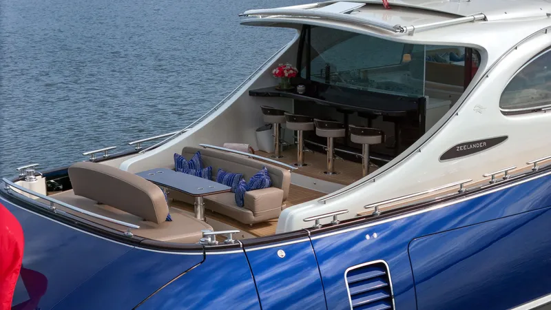 Slide: The Image of Zeelander 72 yacht 2023 model, luxurious outdoor seating and bar area on the water. - 21