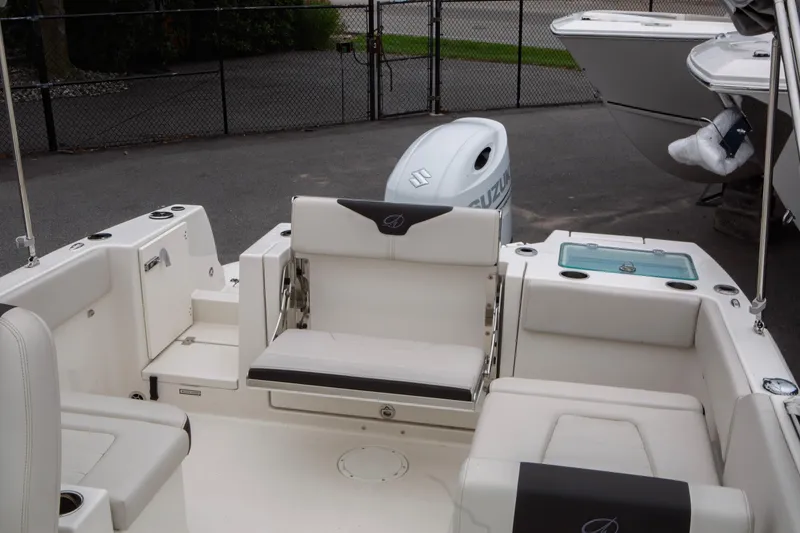 Slide: The Image of 2024 Sailfish 226 DC boat interior with seating and Suzuki outboard motor. - 10