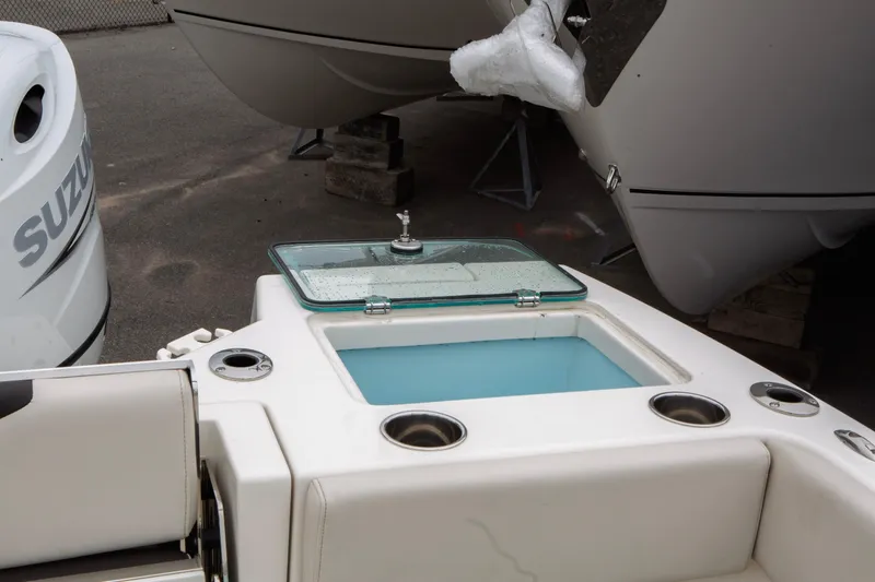 Slide: The Image of 2024 Sailfish 226 DC boat with open livewell and Suzuki engine. - 11