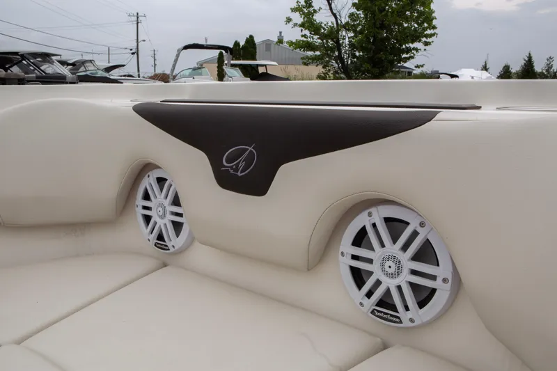 Slide: The Image of 2024 Sailfish 226 DC boat interior with speakers and stylish upholstery. - 14