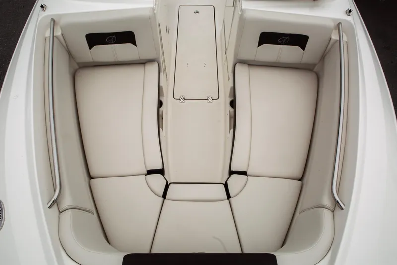 Slide: The Image of 2024 Sailfish 226 DC boat interior with white cushioned seating and storage compartments. - 18