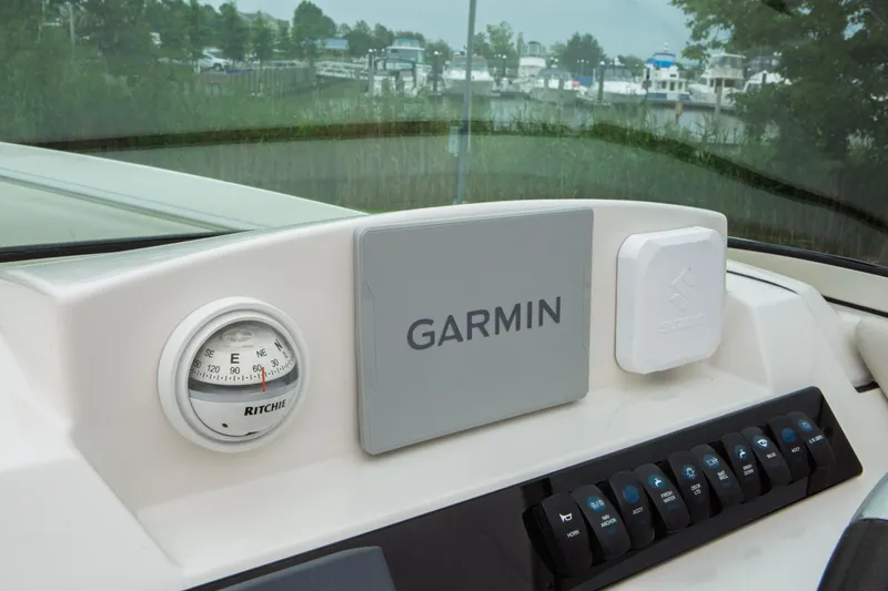 Slide: The Image of 2024 Sailfish 226 DC dashboard featuring Garmin navigation and Ritchie compass. - 20