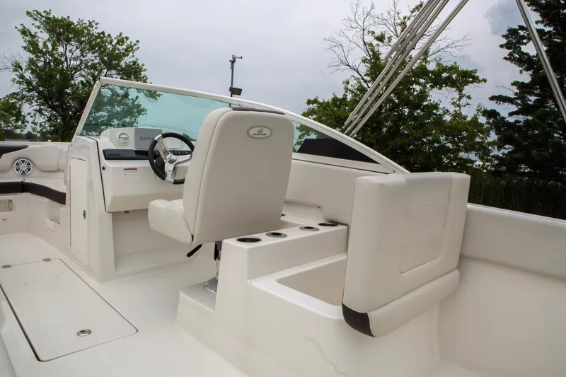 Slide: The Image of 2024 Sailfish 226 DC boat interior with steering wheel and seating. - 25