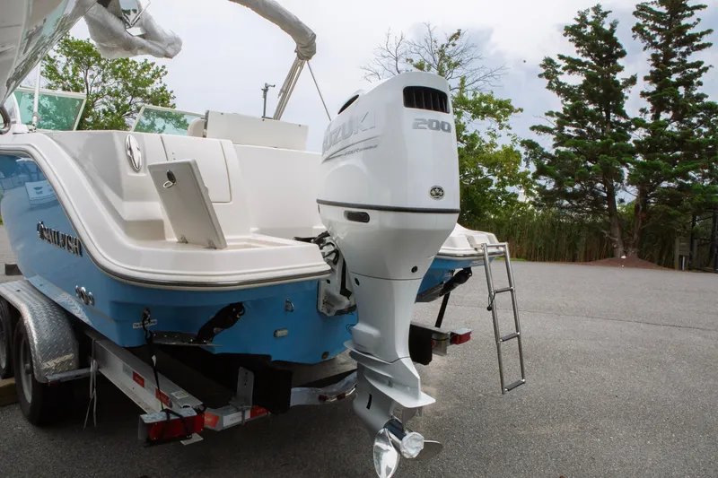 Slide: The Image of 2024 Sailfish 226 DC boat with Suzuki 200 outboard motor on trailer. - 3