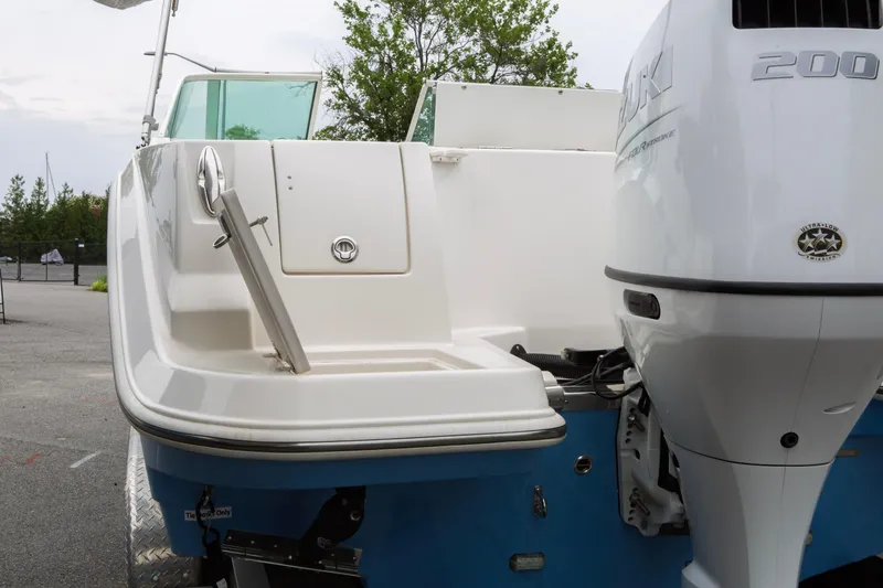 Slide: The Image of 2024 Sailfish 226 DC boat with Suzuki 200 outboard motor, rear view. - 4