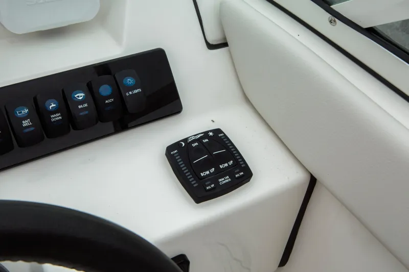 Slide: The Image of 2024 Sailfish 226 DC boat control panel with switches and trim tab controls. - 6