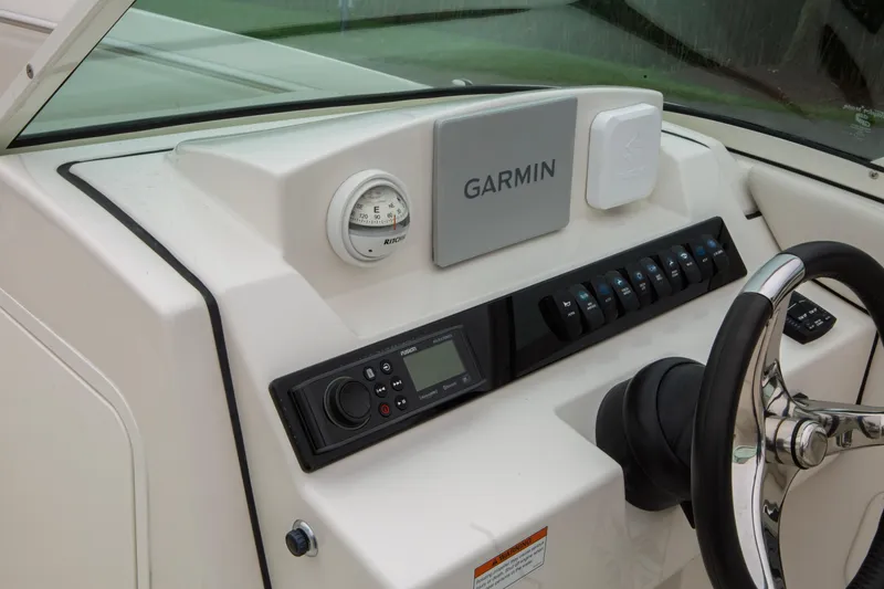 Slide: The Image of 2024 Sailfish 226 DC dashboard featuring Garmin navigation and control panel. - 9