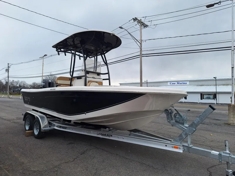 Slide: The Image of 2023 Carolina Skiff 21 Ultra Elite boat on a trailer in a parking lot. - 2