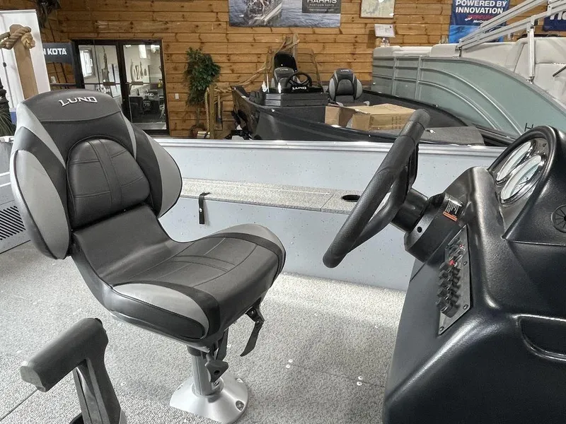 Slide: The Image of 2024 Lund Fury 1600 SS boat interior with steering console and captain's chair. - 10