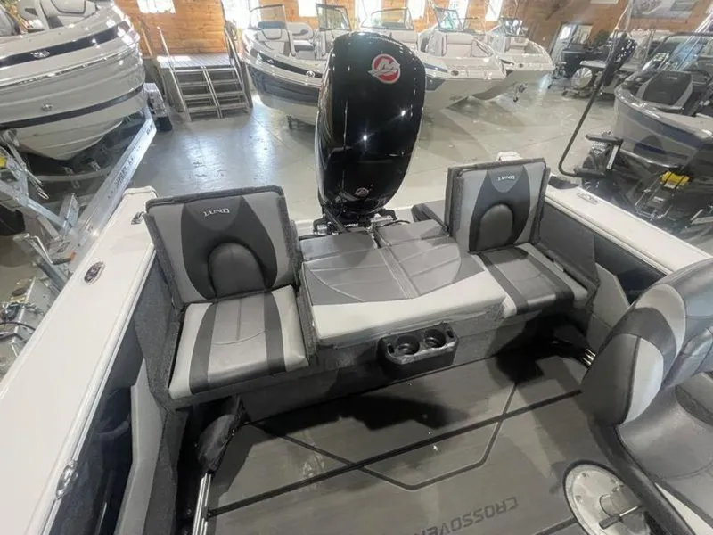 Slide: The Image of 2024 Lund Crossover XS 1875 boat interior with Mercury outboard motor in showroom. - 10