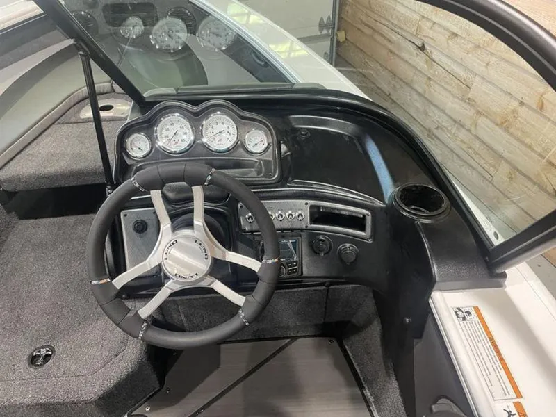 Slide: The Image of 2024 Lund Crossover XS 1875 boat dashboard with steering wheel and gauges. - 13