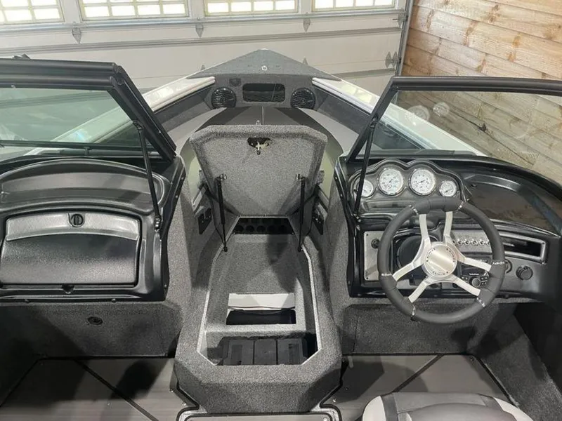 Slide: The Image of 2024 Lund Crossover XS 1875 boat interior with steering wheel and dashboard. - 15