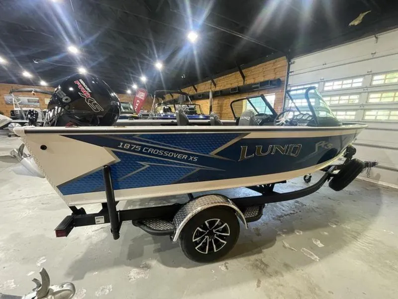 Slide: The Image of 2024 Lund Crossover XS 1875 boat on a trailer in a showroom. - 4