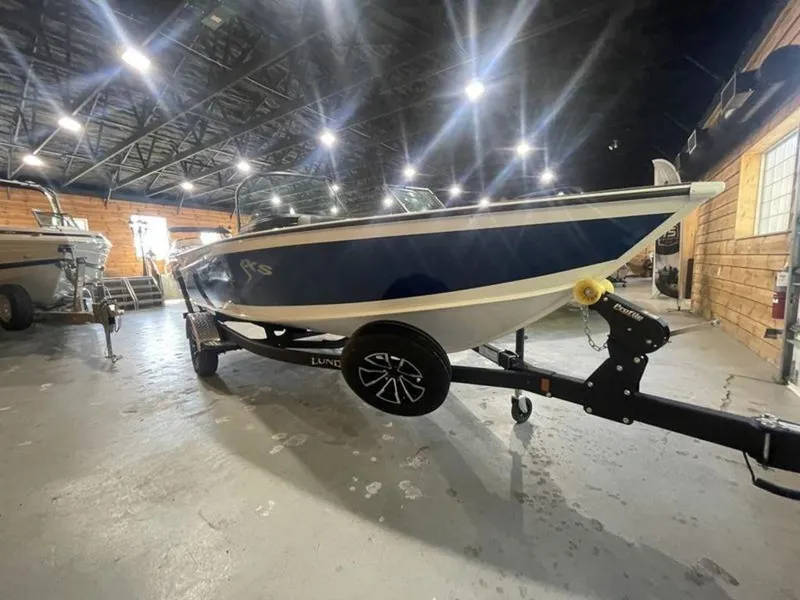 Slide: The Image of 2024 Lund Crossover XS 1875 boat on trailer in indoor showroom. - 5