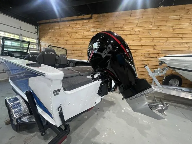 Slide: The Image of 2024 Lund Crossover XS 1875 boat with outboard motor in showroom. - 6